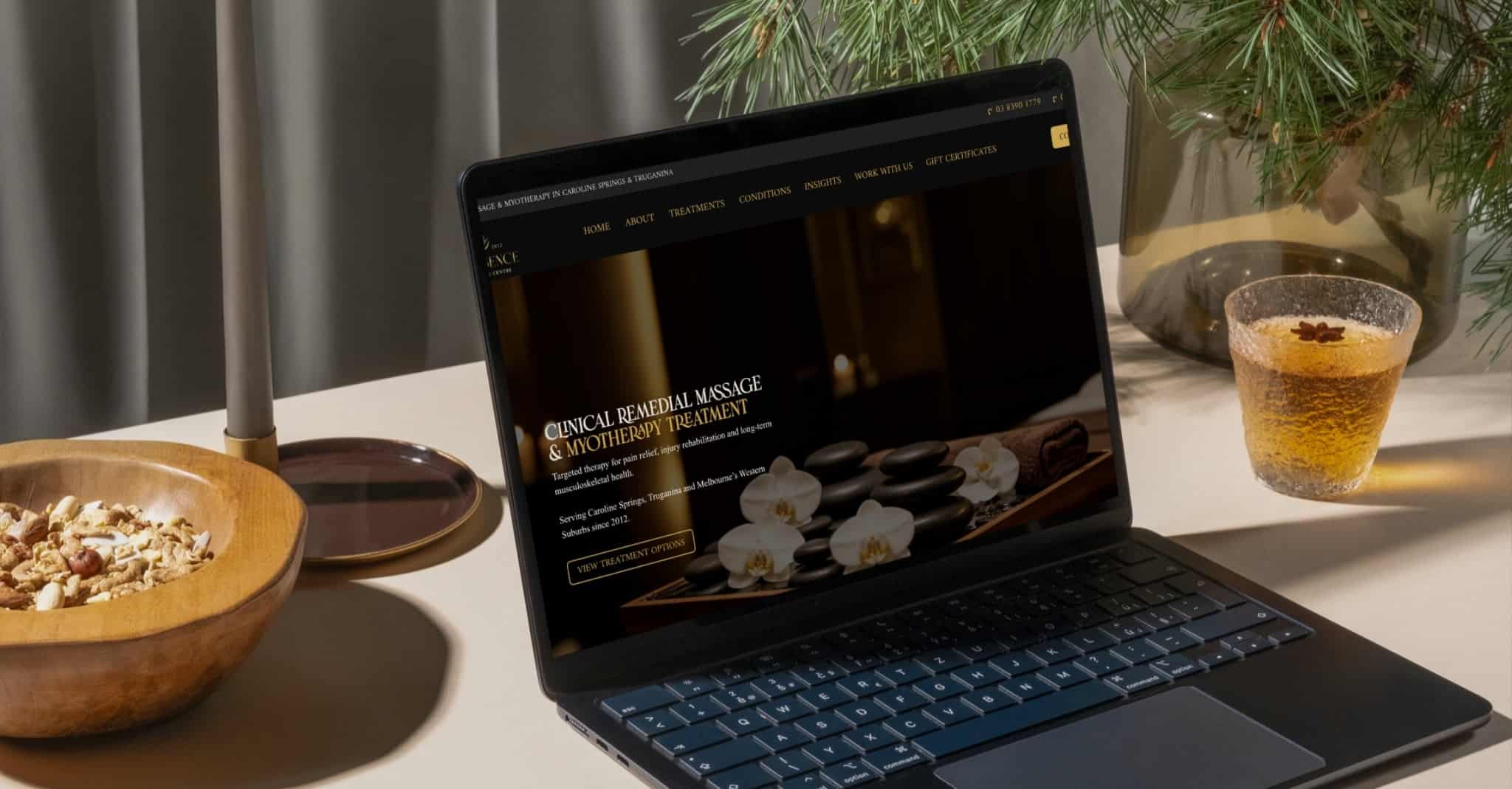 Thai Essence remedial massage website displayed on laptop